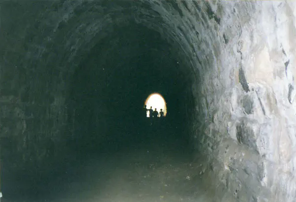Dark tunnel to a waterfall