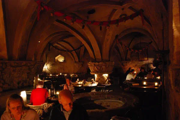Inside a medieval restaurant. Diner with candle light, live music and folkloric costumes