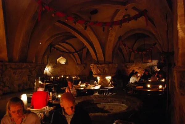 Inside a medieval restaurant. Diner with candle light, live music and folkloric costumes