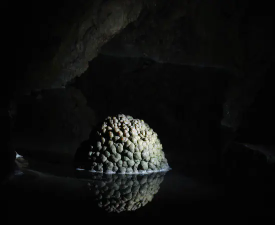 An artifical lake with a beehive. The underground lake had to be drained to make the grottos accessible and a shaft was constructed here by human hands to divert the water into the Lorze. The &quot;beehive&quot; is an underwater formation that was moved into the modern artifical lake.